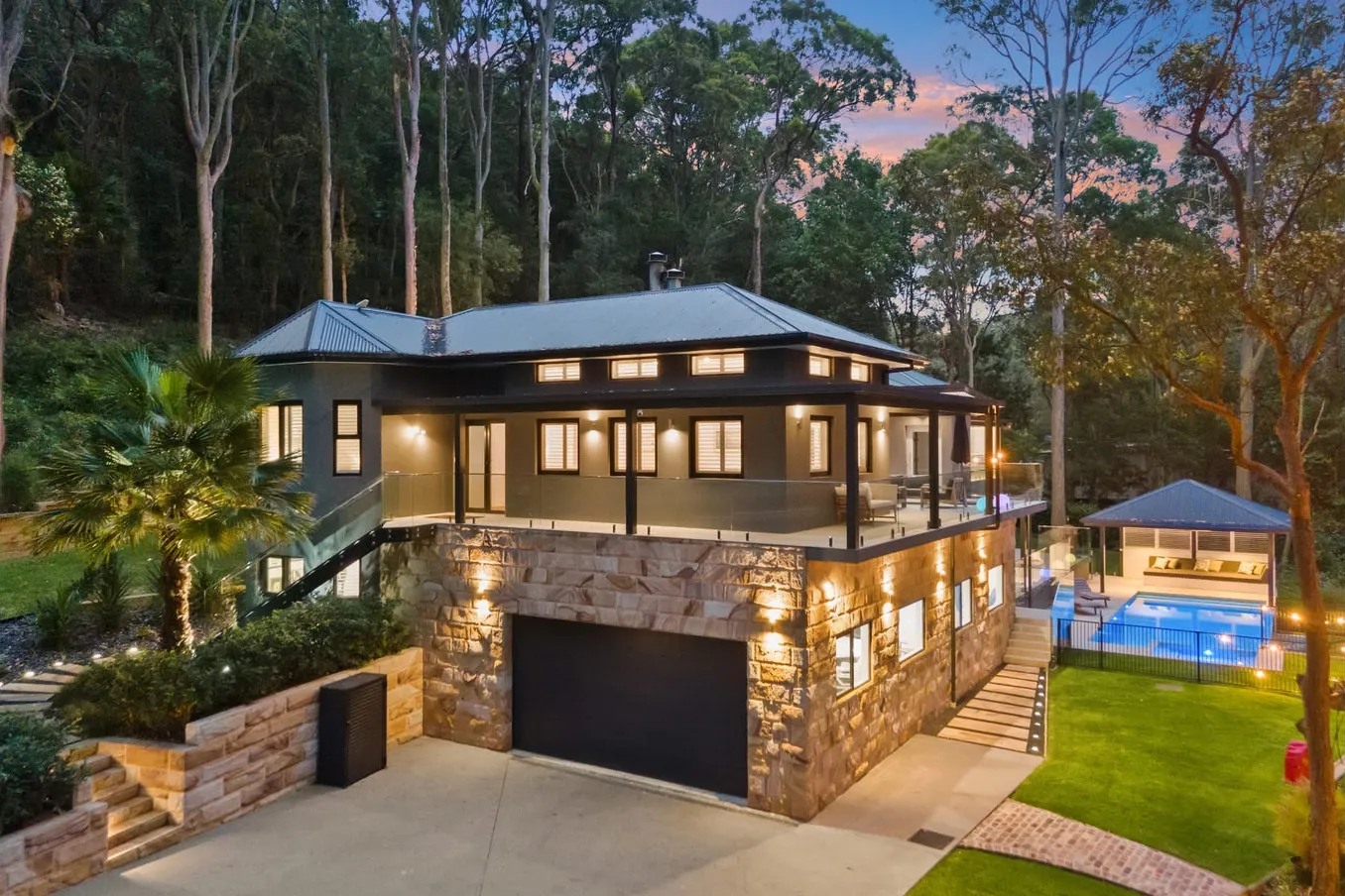 Front of the home with stone base and garage