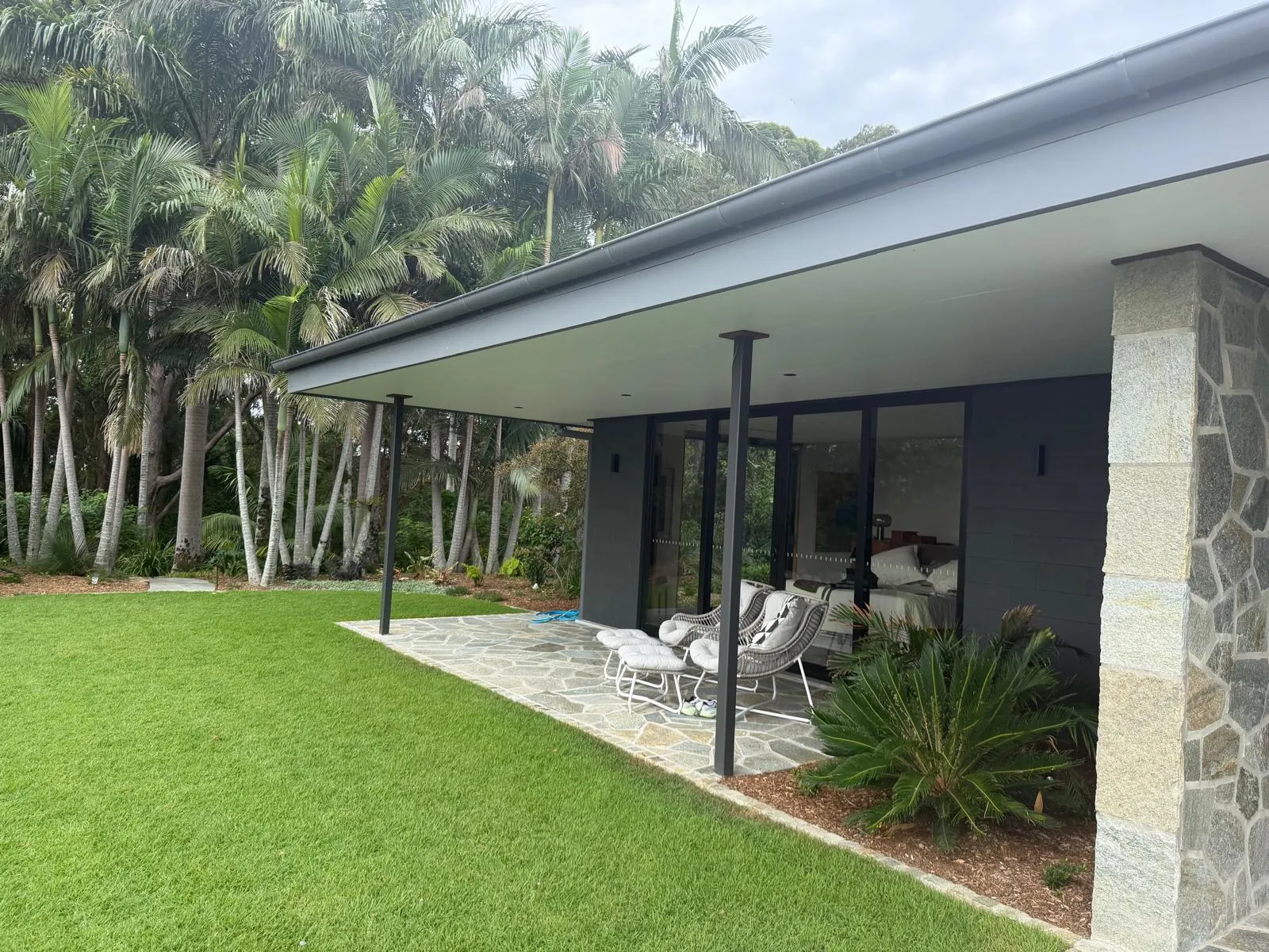 Covered terrace and garden beside the home
