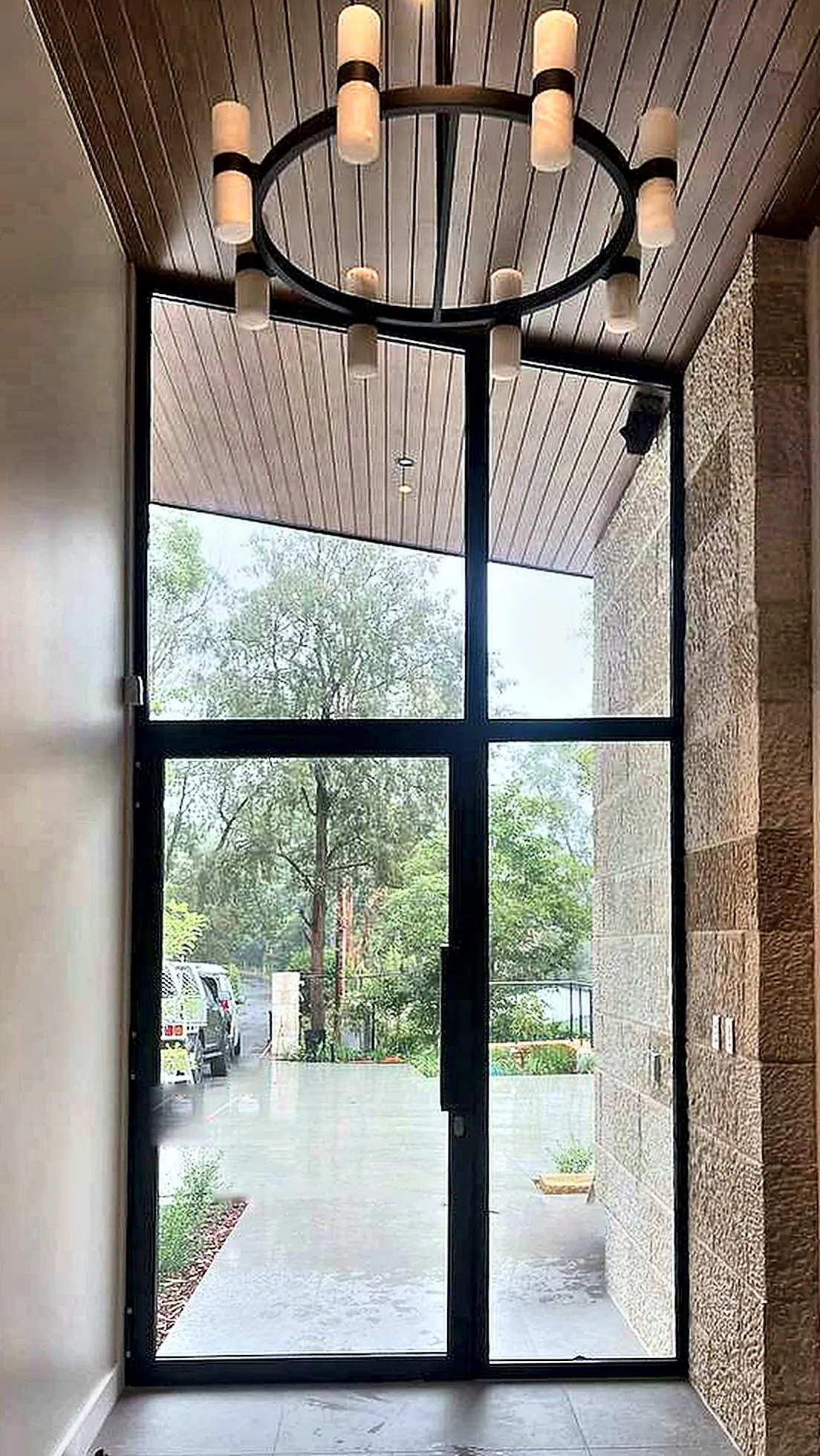 Double-height entry door with fixed glazing above