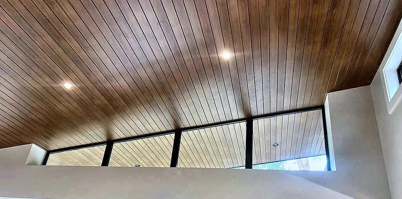 Clerestory windows under the timber-lined ceiling