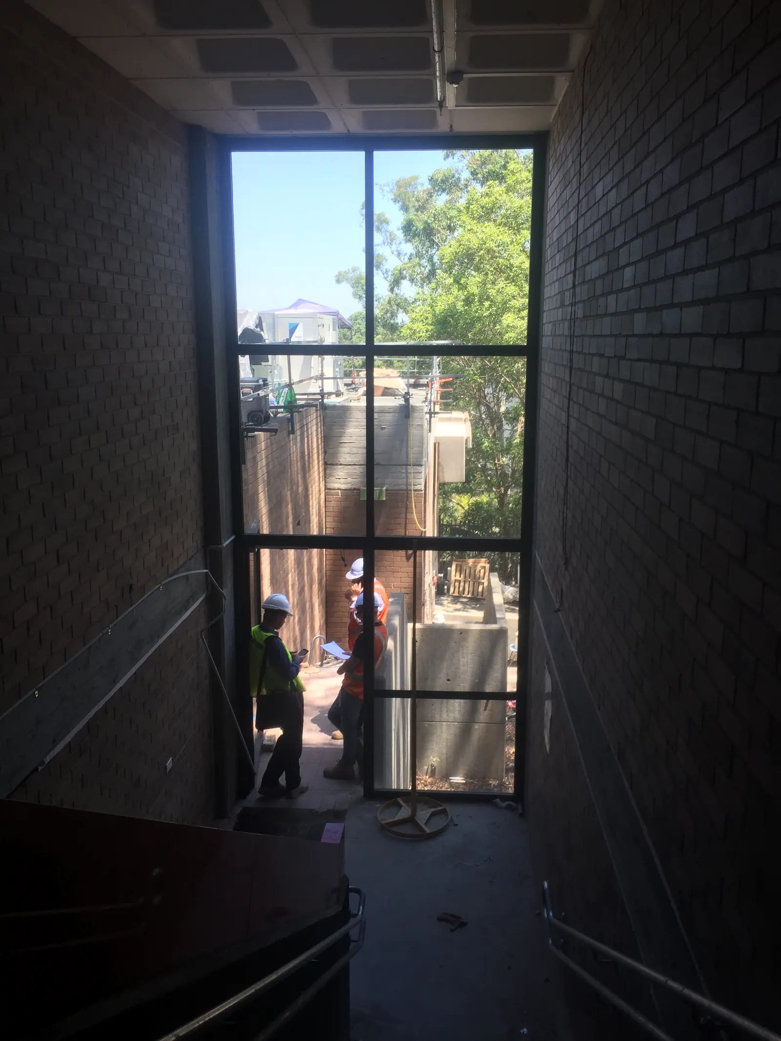 Tall glazed opening in a brick wall